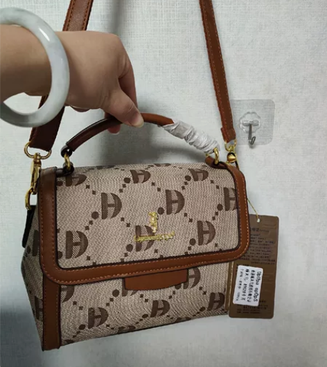 编号H12，全新香港啄木鸟手提包单肩斜挎女...